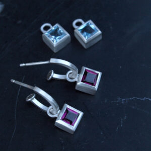 Silver hoop earring with square cut Rhodelite garnets